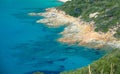 Turquoise Mediterranean sea with cumulus clouds at the Plage de l`Alga on the rocky coast of La Revellata near Calvi.